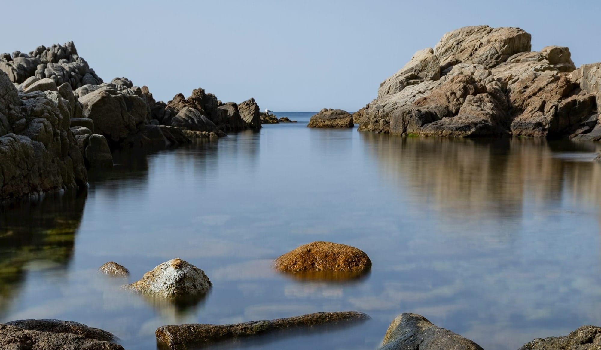 a group of rocks in a body of water